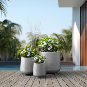 Kante round concrete planter ample growing space for trees, succulents, or flowers.