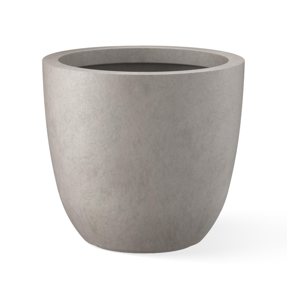 Kante round concrete planter on outdoor display adds modern curb appeal.