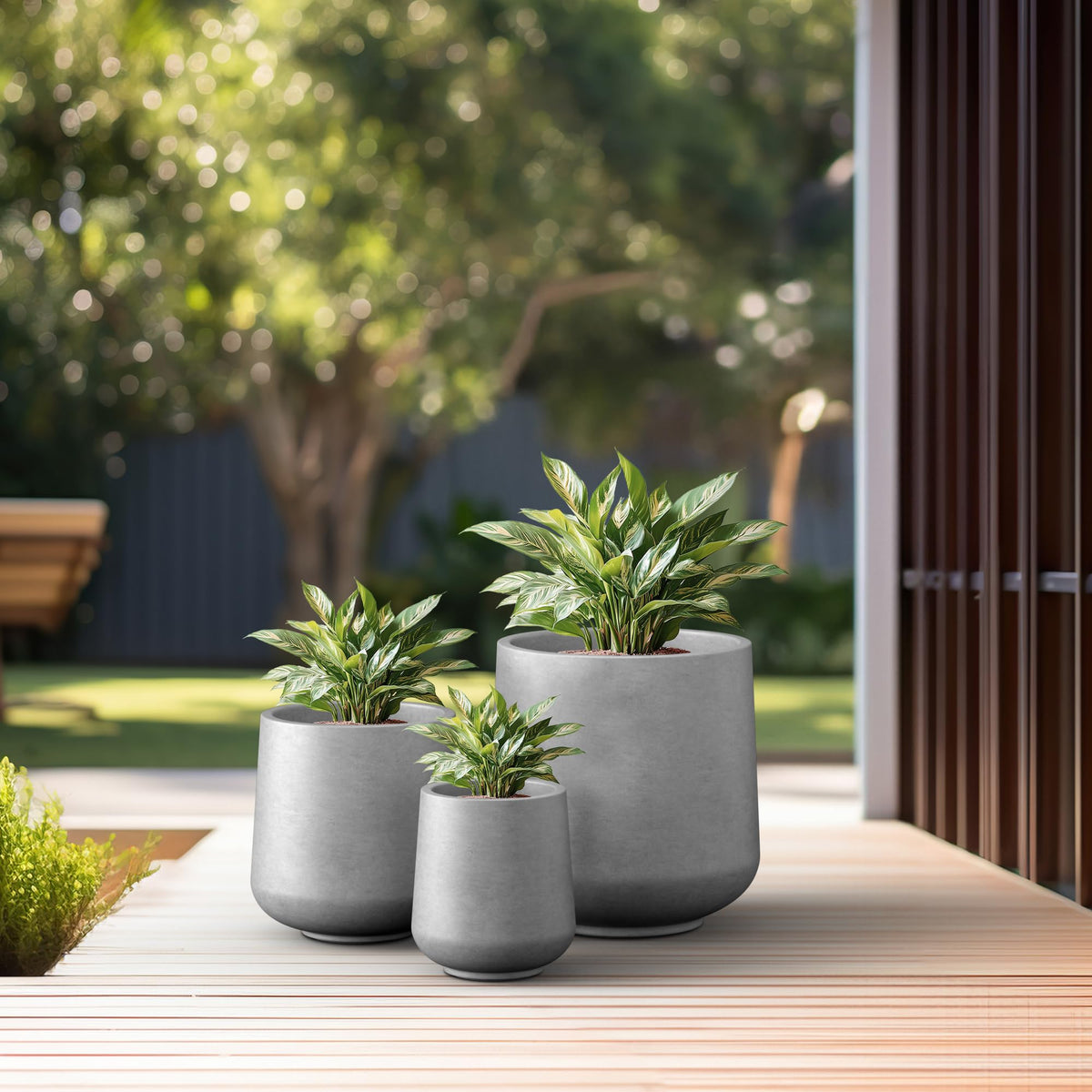 Kante round concrete planter outdoor patio setup for lush plants in modern space.