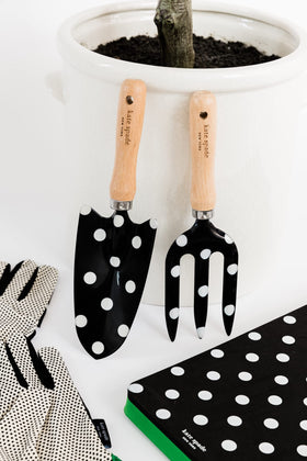 Kate Spade New York hand rake with wooden handle for steady digging.