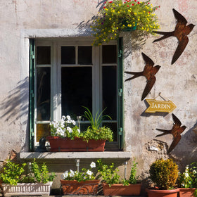 Kathfly small rusty bird decor accents outdoor walls with vintage appeal.