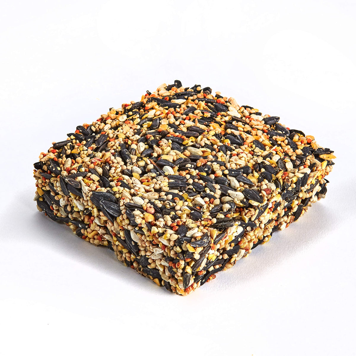 Seed cake being placed into a cake feeder for easy feeding