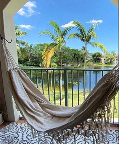 KEREITH boho fringe hammock enhancing bedroom or patio decor.