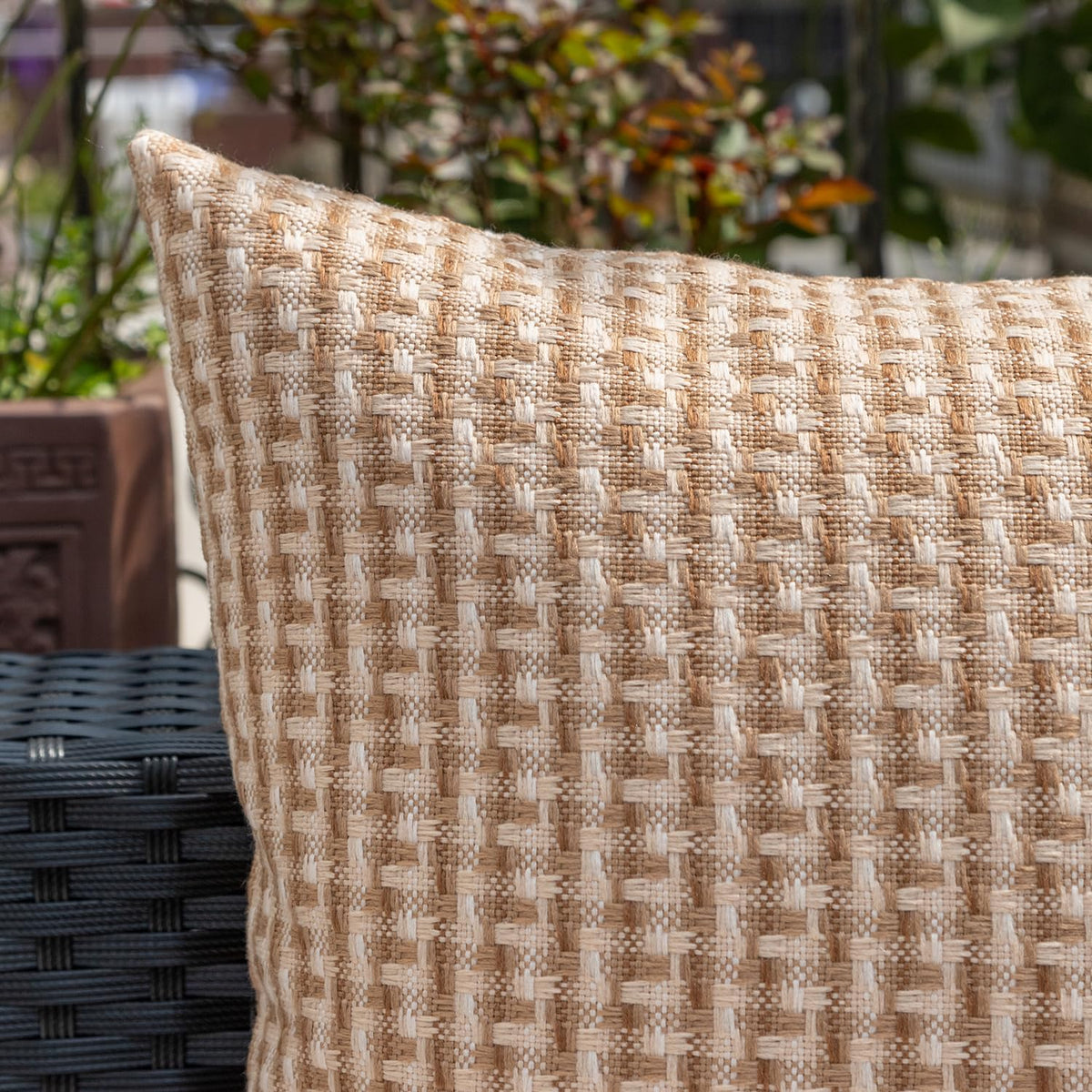 Kevin Textile pillow cover styled on a sofa outdoors.