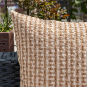 Kevin Textile pillow cover styled on a sofa outdoors.