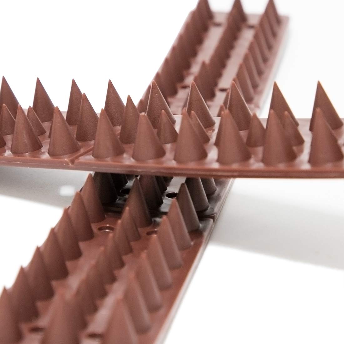 Kimann 20-pack bird spikes defender on a roof edge helps deter intruders.