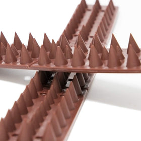 Kimann 20-pack bird spikes defender on a roof edge helps deter intruders.
