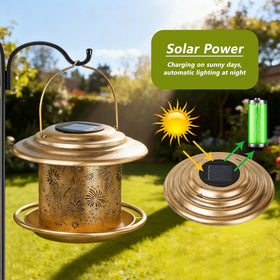KIMERSE hanging lantern-style feeder glows softly in the garden at night.