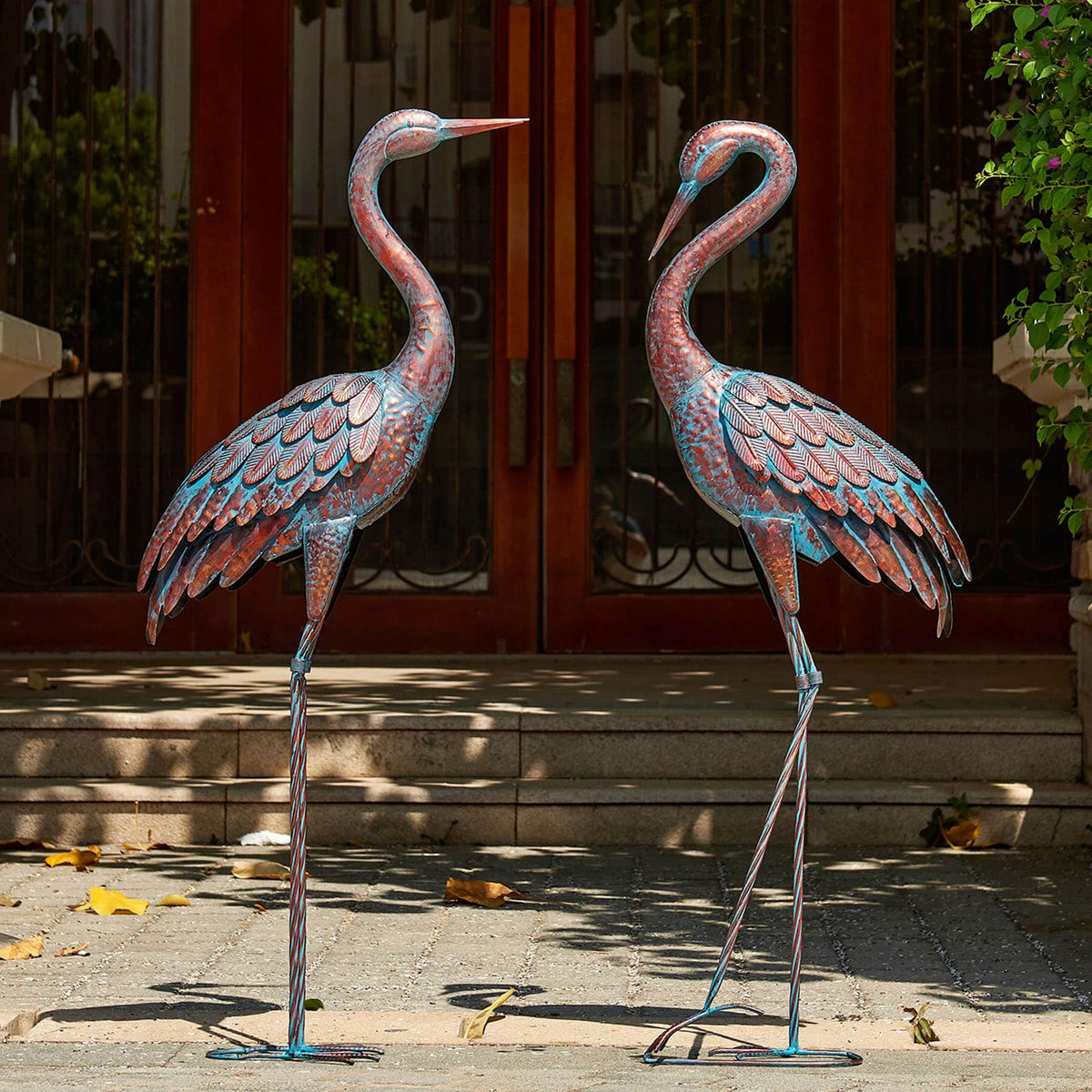Kircust garden crane statues with patina finish add elegant outdoor decor.