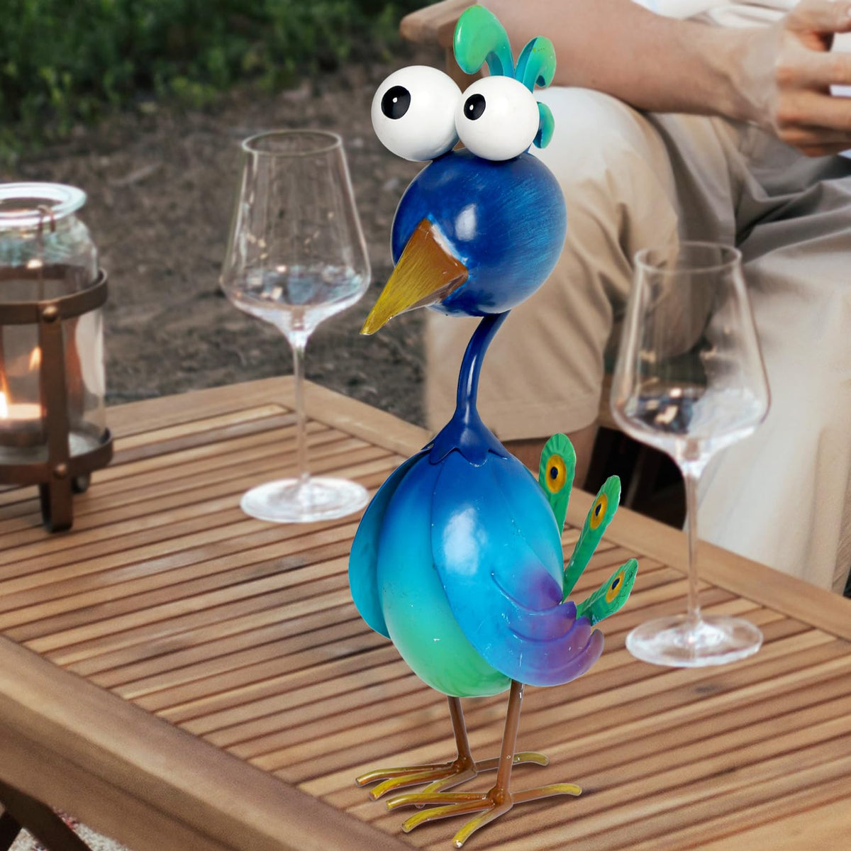 Kircust Peacock decor on lawn fits compact outdoor spaces.