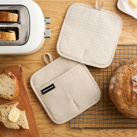KitchenAid Gridlines pot holder highlighting slip-resistant silicone palm for secure gripping.