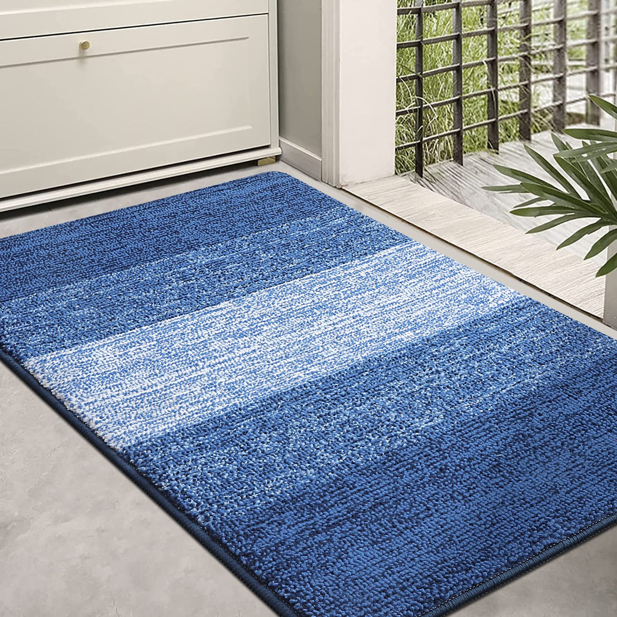 Kitinjoy navy blue door mat absorbs moisture at entryways.
