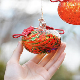 KRISININE colorful glass feeder catches sunlight for eye-catching yard display.