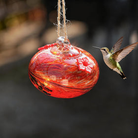 KRISININE glass hummingbird feeder on garden window display.