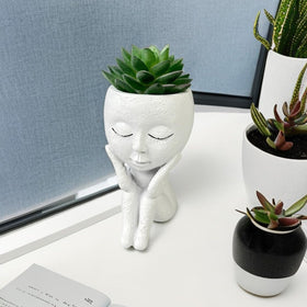 Kudriod face planter for outdoor garden decor adds whimsy to patios.