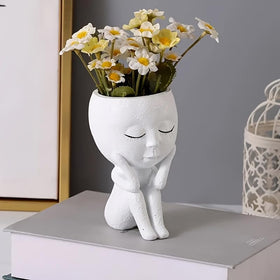 Kudriod resin face pot showcases small plants with durable, lightweight design.
