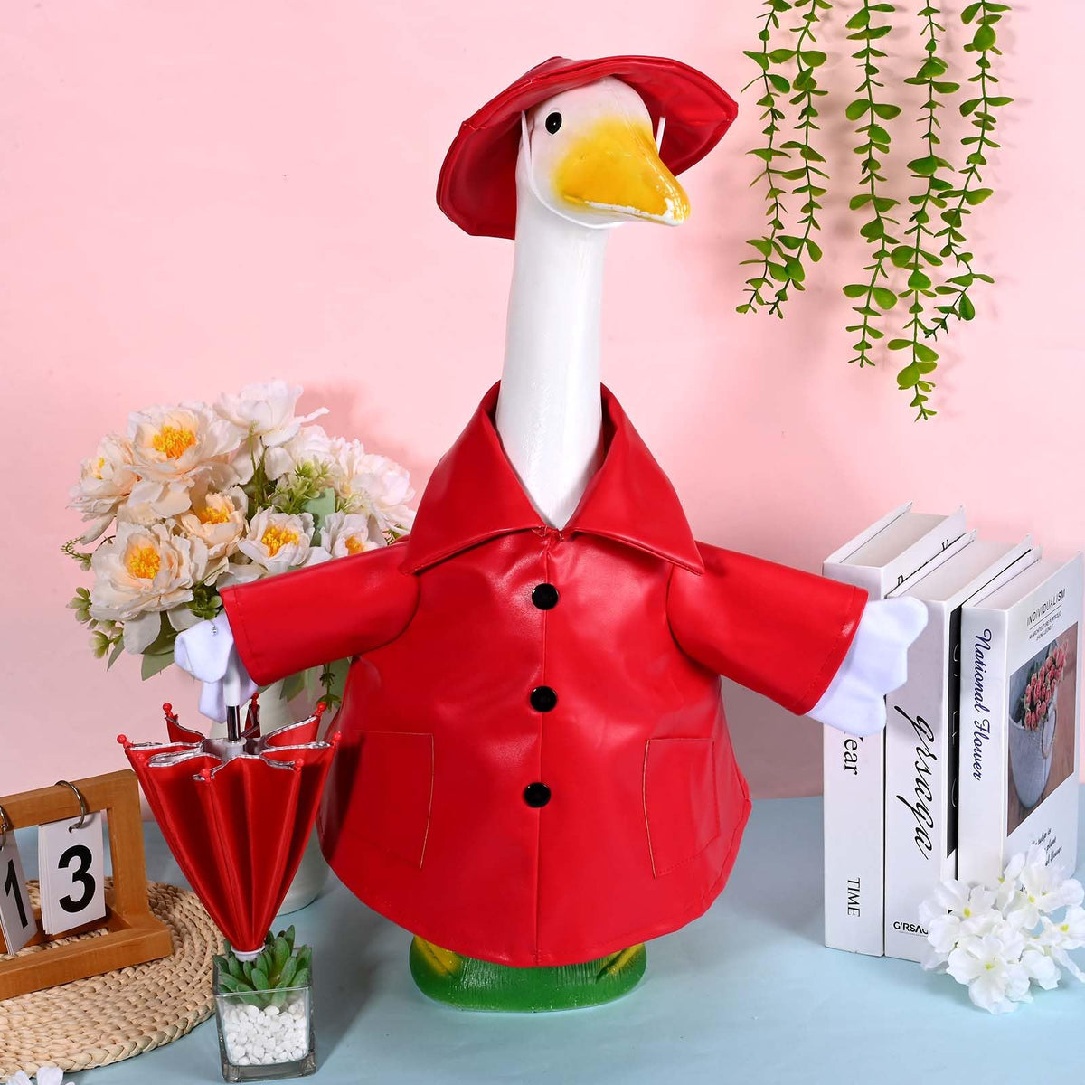 Kuscul goose wearing red leather-look raincoat and umbrella