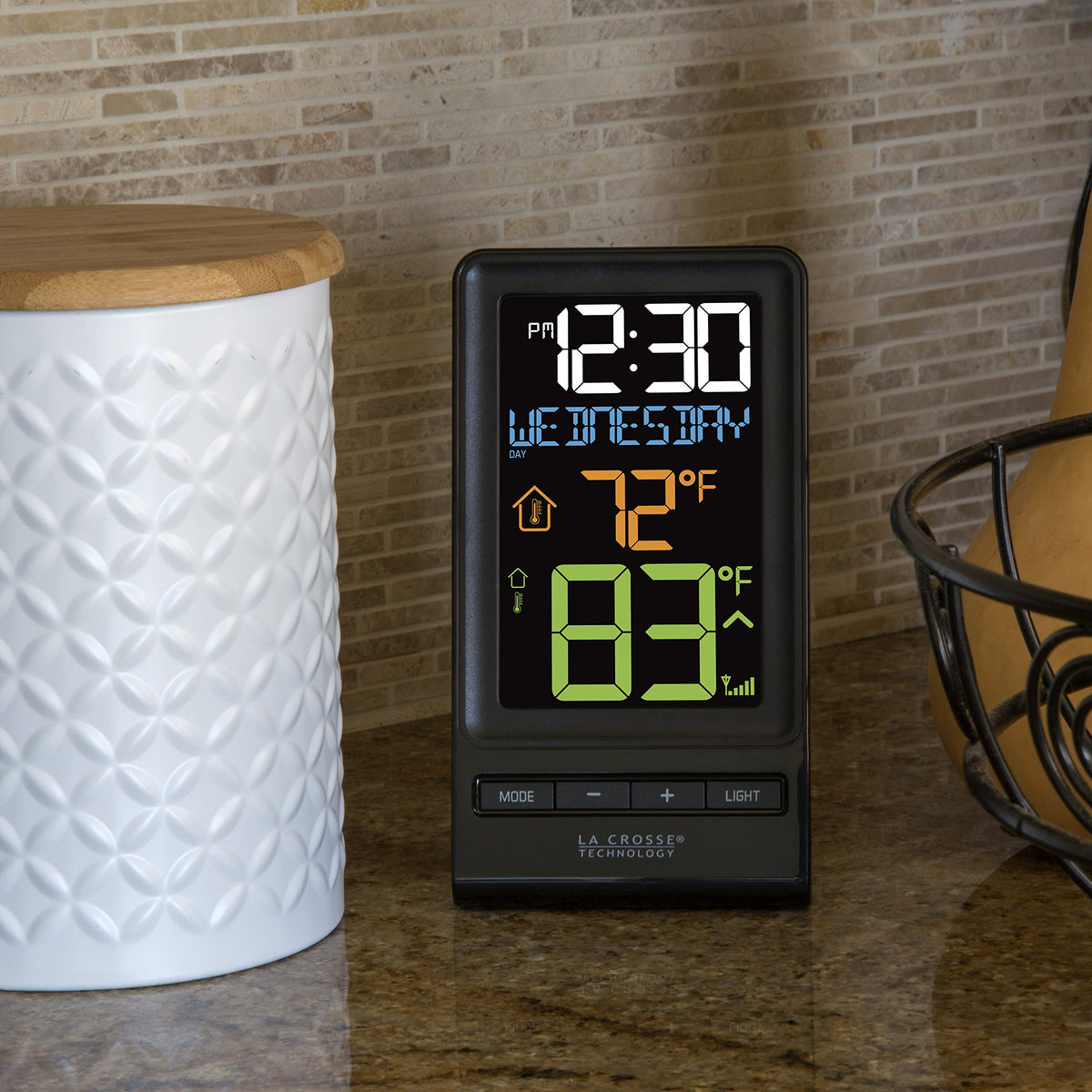 La Crosse Technology 308-1415 thermometer display shows wireless outdoor temperature data in color.
