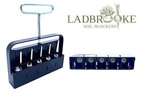 Ladbrooke Mini 5 ejection handle releasing a soil block for potless sowing.