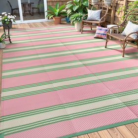Lahome striped outdoor rug in pink and green, ideal for stylish patio spaces.