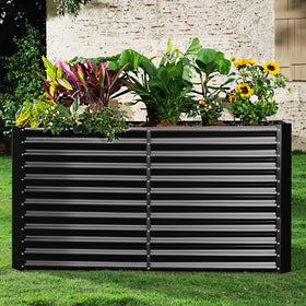 Outdoor garden area featuring a spacious Land Guard raised bed