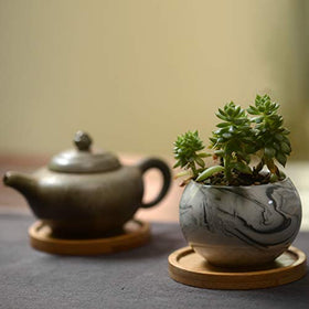Lawei bamboo saucer used as a coaster to protect surfaces.