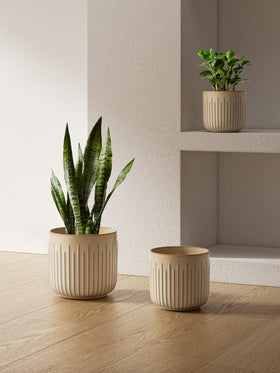 Three LE TAUCI pots stacked on a shelf create a layered home look.