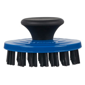 Le Creuset grill pan brush closeup showing nylon bristles for stubborn residue removal.