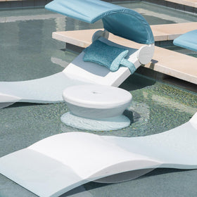 Ledge Lounger white table on pool ledge showcases rust-free, no-maintenance design.