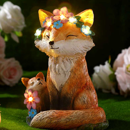 Leinuosen fox family statue in garden with solar light for warm evenings.