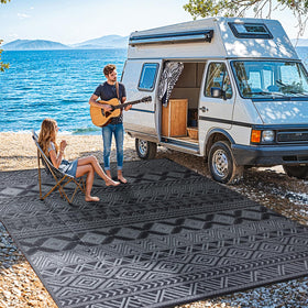RV camping setup featuring LIANLAM rug with corner stakes