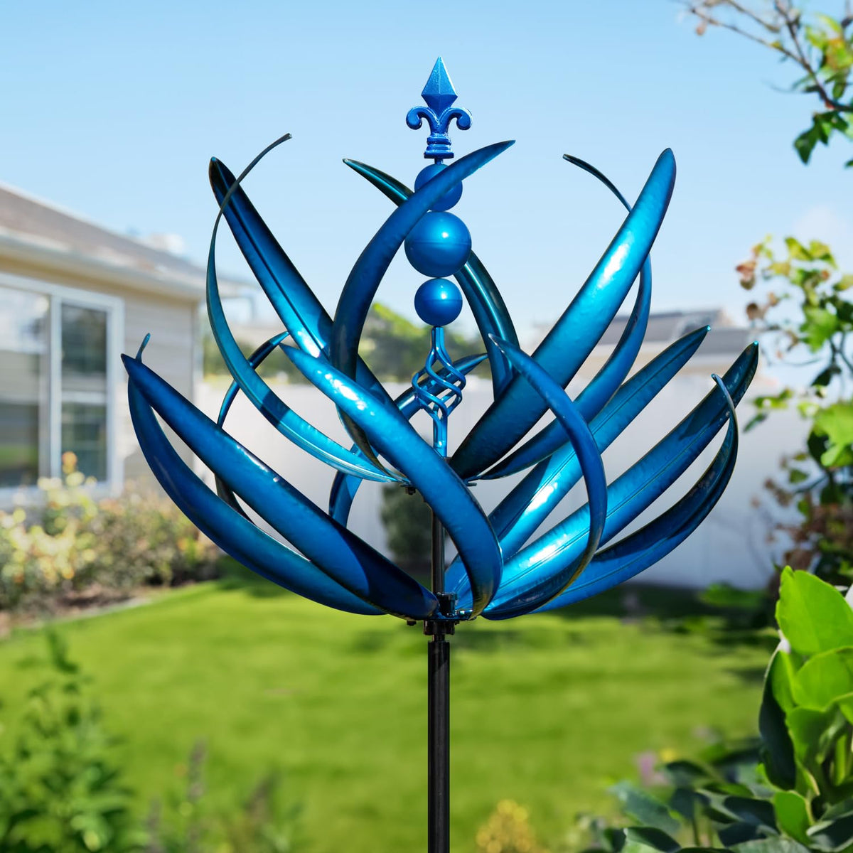 LimeHill wind spinner for yard shows large metal motion in sunlight.