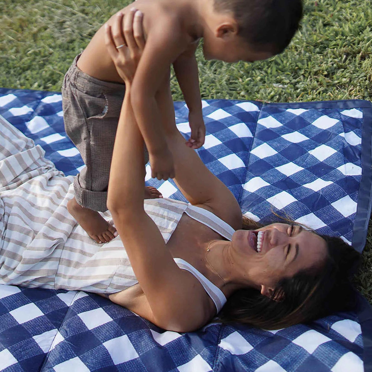 Little Unicorn blanket on a beach scene provides ample space for family