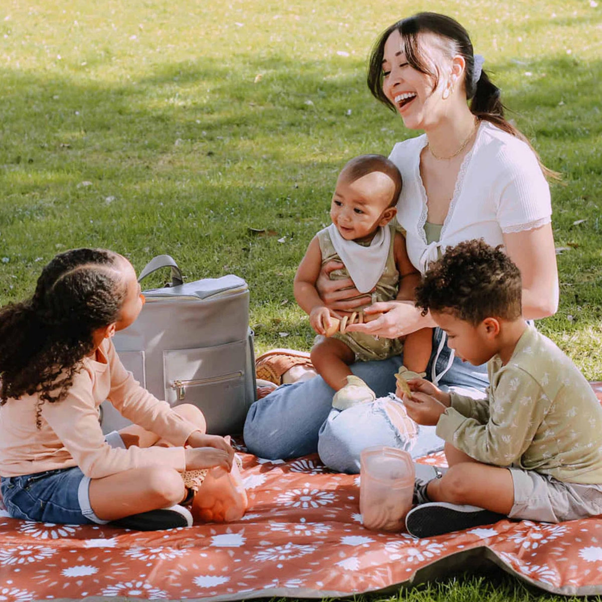 Little Unicorn picnic blanket folded compact for easy car trips and storage.