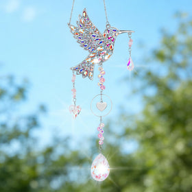 LOKOZ sun catcher in garden setting catching light after rainfall.