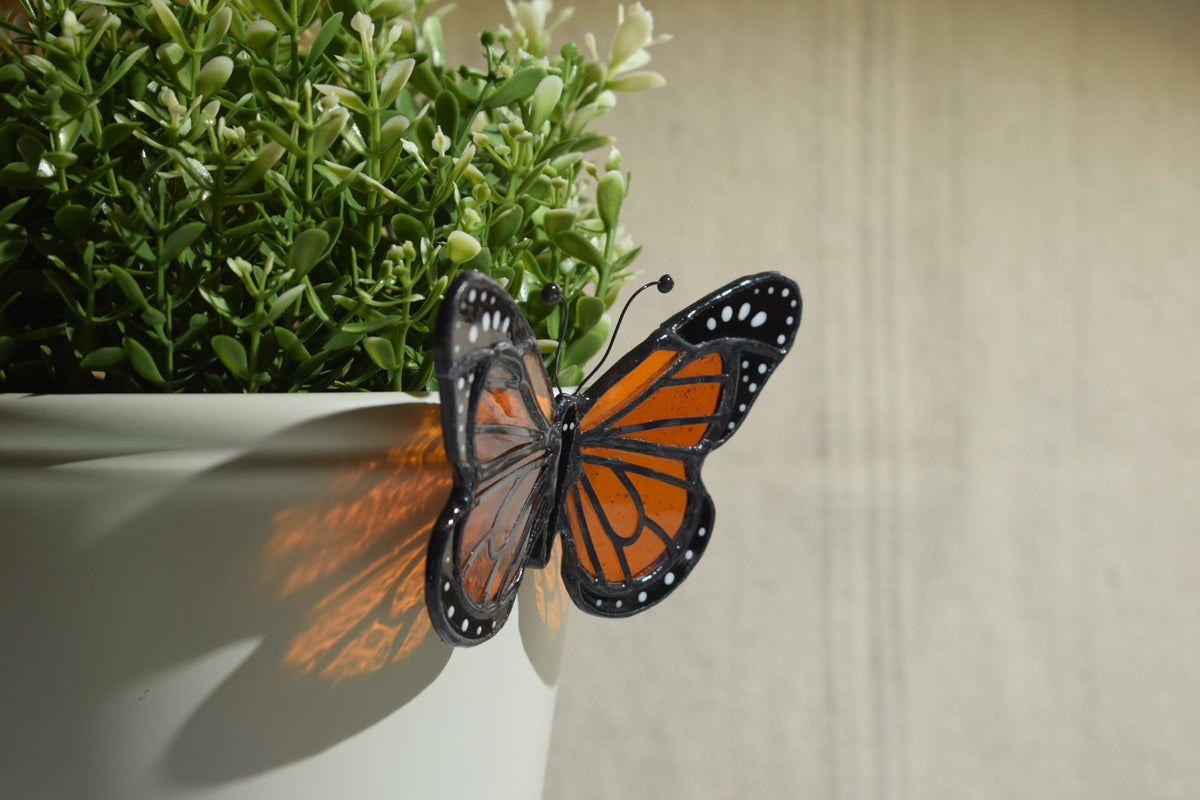 Lolitarcrafts butterfly garden art stained glass enhances plant displays.