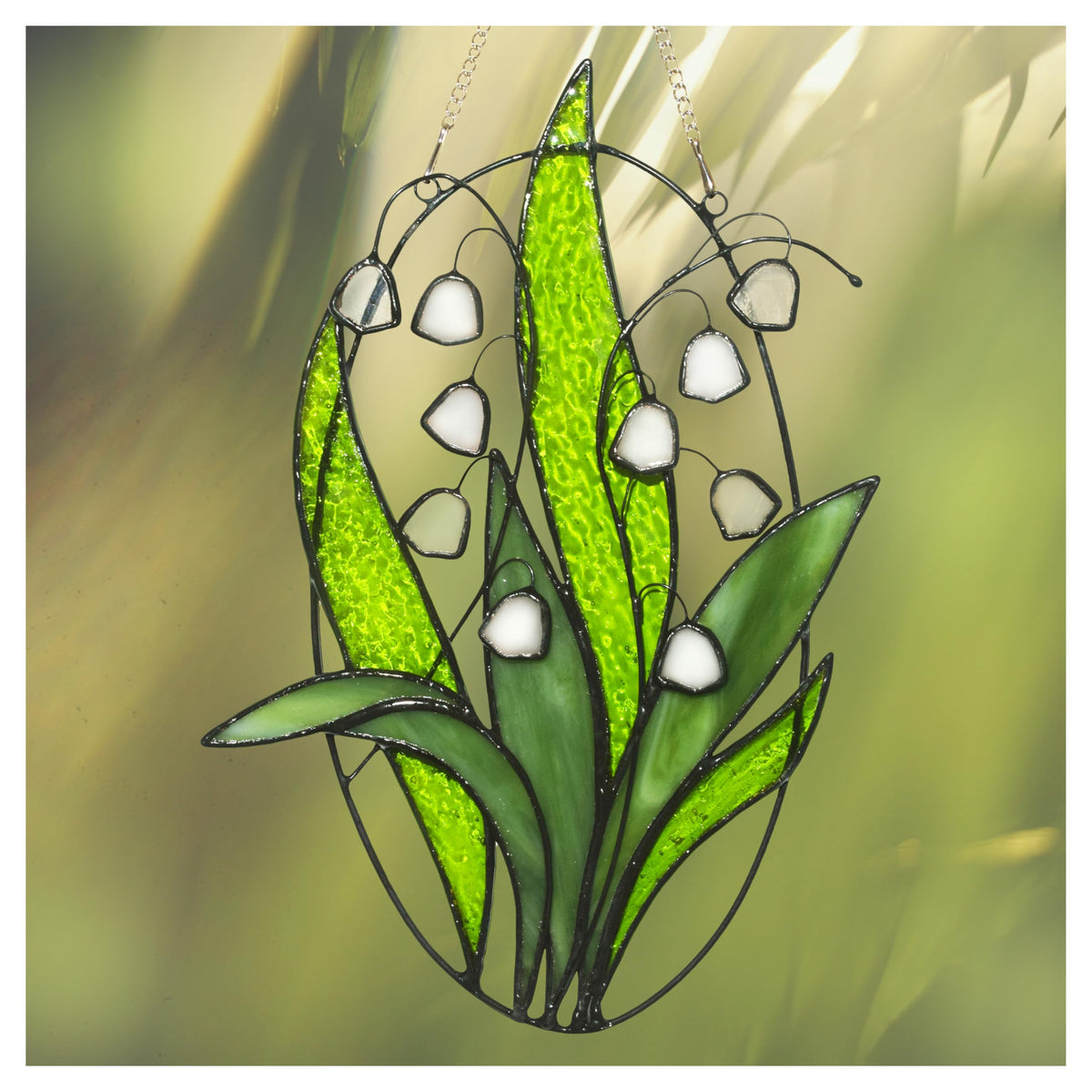 Lolitarcrafts Lily Valley stained glass suncatcher close-up of translucent white bells catching sunlight to brighten rooms
