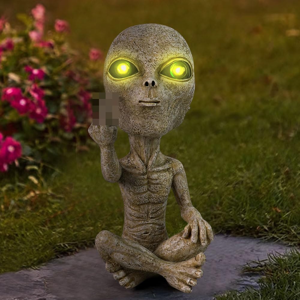 Lopoti Solar Light Alien Statue at night glow enhancing backyard ambience.
