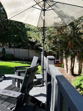 LOVE YOUR DECK completes a compact patio setup with an umbrella ready for sunny afternoons