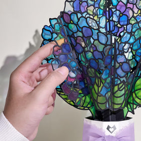 Lovepop hummingbird detail adds graceful movement to birthday decor.