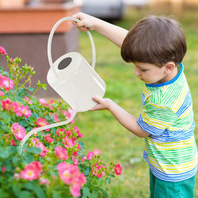 LTSUMI long-spout watering can near leaves and pots for precise pours.