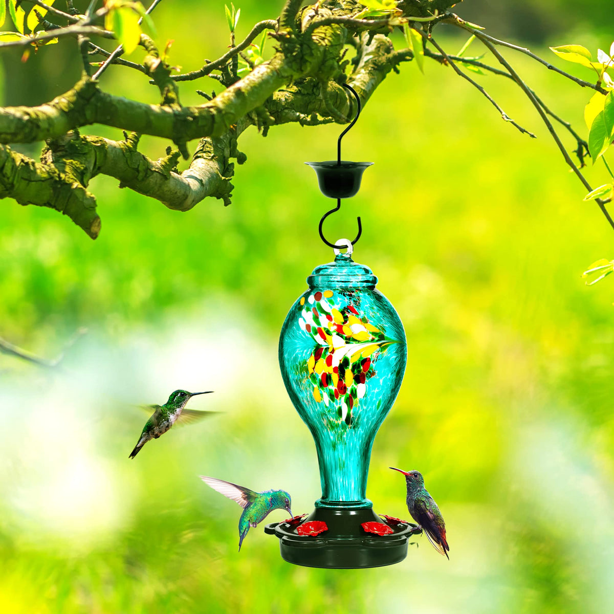 LUJII teal hand blown glass feeder catching sunlight in garden