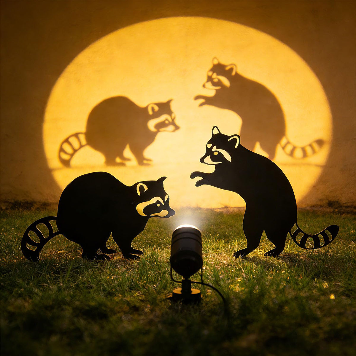 Lume Cradle raccoon stake accents a patio with woodland charm.