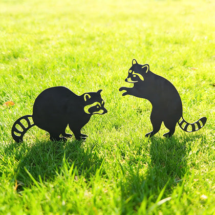 Lume Cradle standing raccoon stake adds charming silhouette along a garden path.