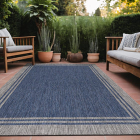 Luul Home bordered outdoor rug 6x9 navy border ideal for patios and entryways.