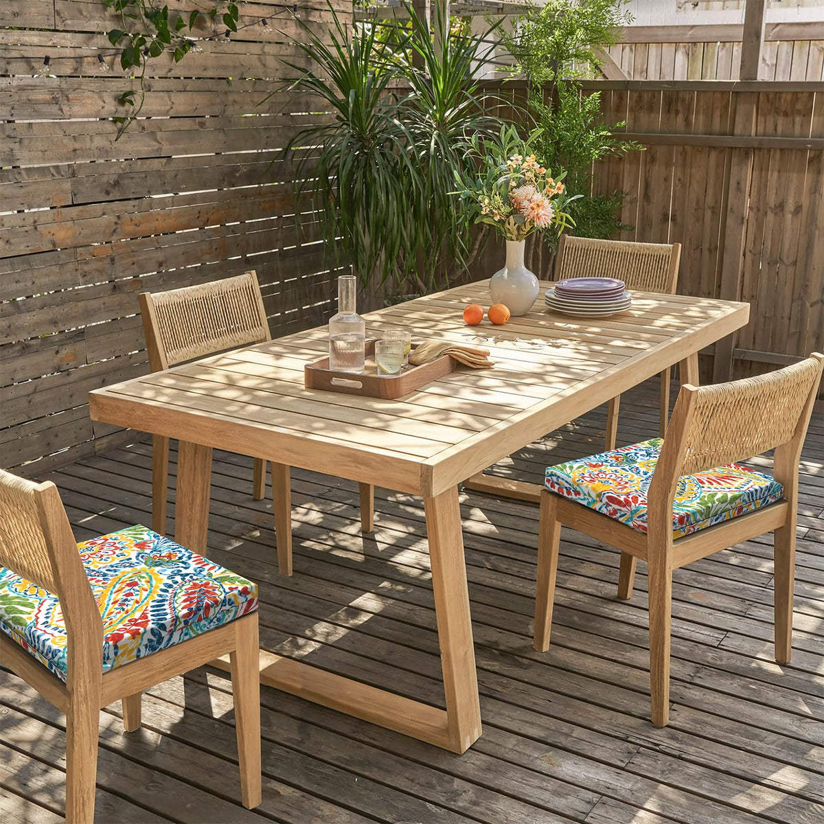 Patio dining area with LVTXIII cushions on chairs outdoors