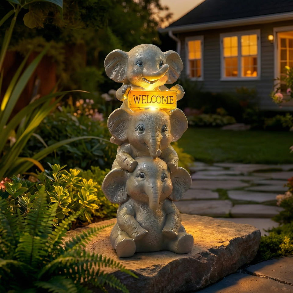 Lyeasw solar elephant garden statue with welcome sign glowing warmly on the porch