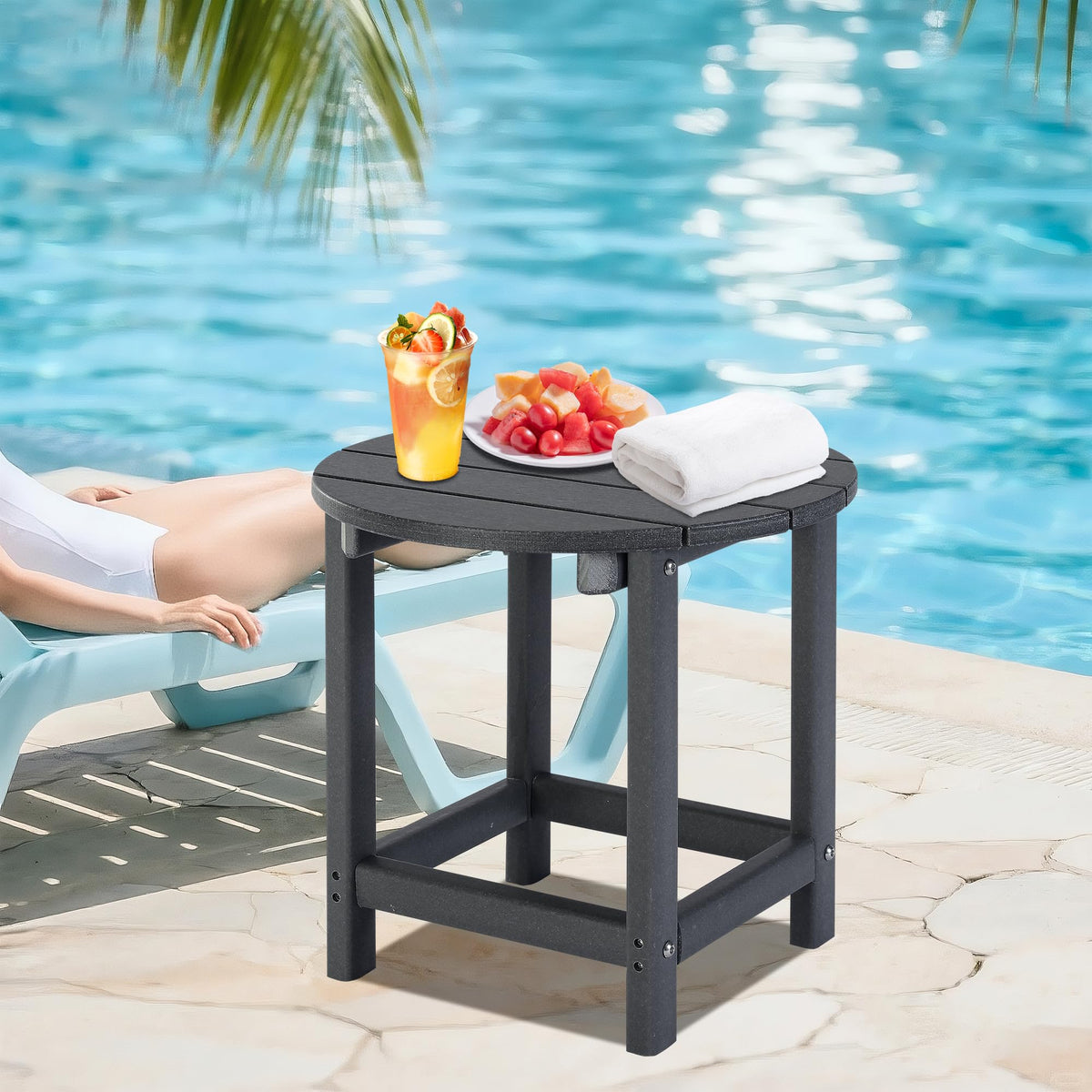 LZRS round Adirondack side table in grey shown in a garden setting.