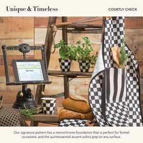 MacKenzie-Childs enamel herb pots with hand-painted checks brighten a countertop centerpiece.