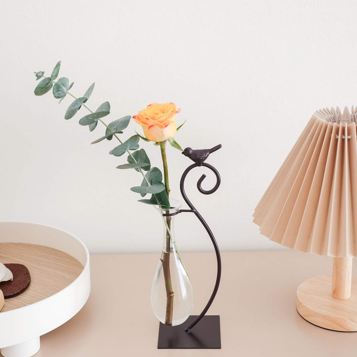 Marbrasse glass planter with flowers brightens a desk.